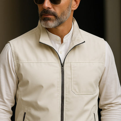 Men’s lightweight utility vest in ivory, worn on model, zip front with chest pocket and side zip pockets.
