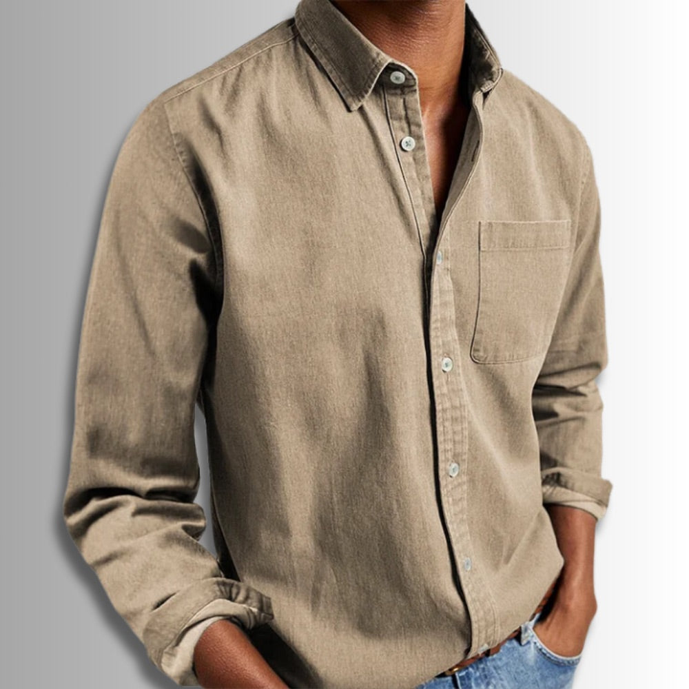 Beige button-up shirt worn by a person on a gray background
