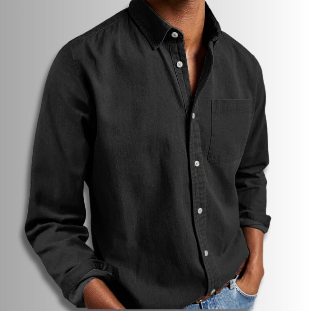 Black button-up shirt worn by a person on a gray background