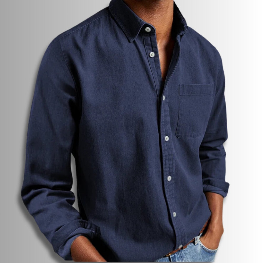 Navy blue button-up shirt worn by a person on a gray background
