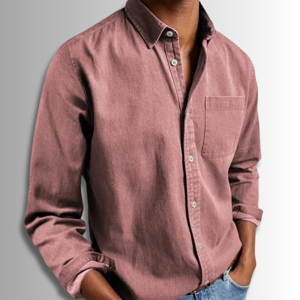 Pink button-up shirt worn by a person on a gray background
