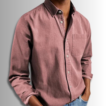 Pink button-up shirt worn by a person on a gray background