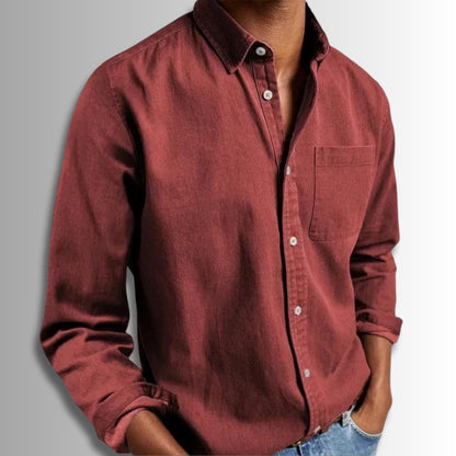 Maroon button-up shirt worn by a person on a gray background