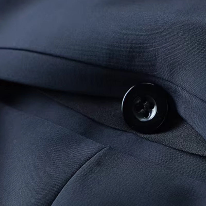 Close-up of Polumi Fabio Luxe Office Slacks navy fabric and button — showcasing premium craftsmanship and smooth texture.