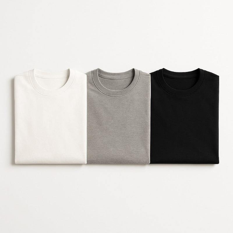 Polumi men’s T-shirts — white, grey, and black cotton tees folded flat, representing simplicity and modern essentials.