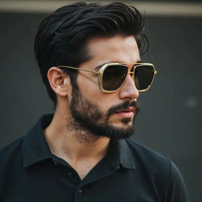 Stylish man wearing golden aviator sunglasses with black lenses, elegant and modern eyewear look.