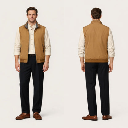 Man wearing a tan vest over a white shirt with black pants on a white background