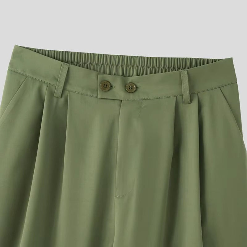 Close-up of waistband and pleats on Torino Men’s Soft Suit trousers in army green.