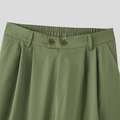 Close-up of waistband and pleats on Torino Men’s Soft Suit trousers in army green.