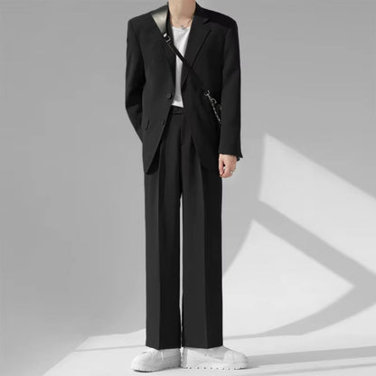 Model wearing Torino Men’s Soft Suit in black with white sneakers, minimalist Italian fashion look.
