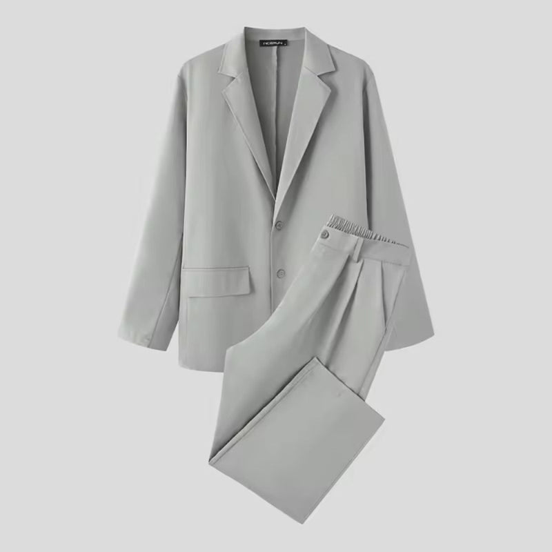 Torino Men’s Soft Suit in light gray laid flat, showing soft material and modern tailoring.
