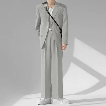 Model wearing Torino Men’s Soft Suit in light gray, casual Italian-inspired elegance.