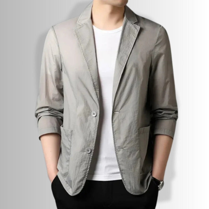 Man wearing Valerio Cascade Blazer in gray paired with white t-shirt and black trousers.