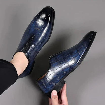 Valerio Leather Loafers in navy, men’s luxury slip-on loafers worn with elegant tailored pants.